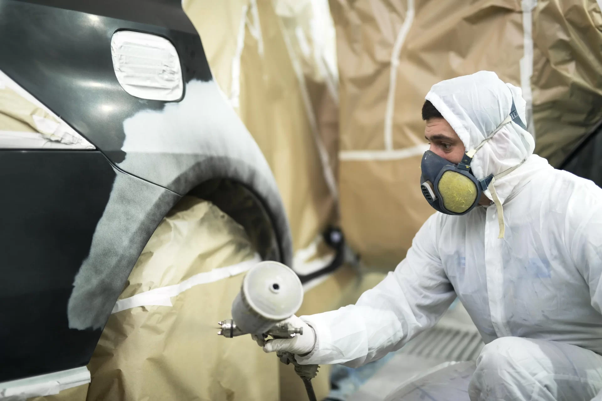 man-with-protective-clothes-mask-painting-automobile-car-bumper-repair-shop_web.webp